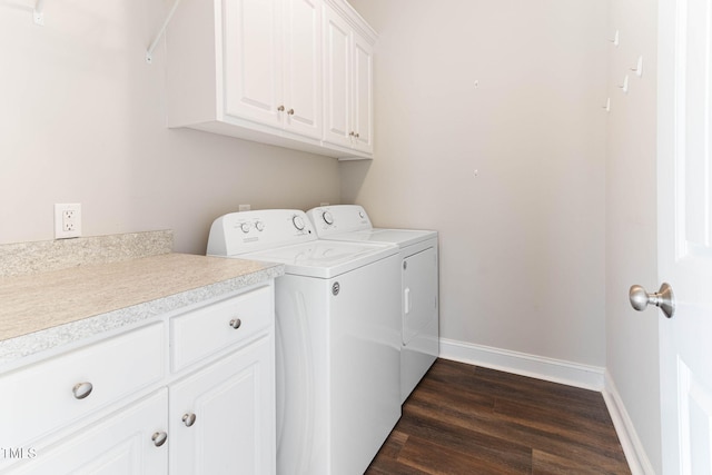 washroom featuring cabinet space, baseboards, dark wood-style flooring, and independent washer and dryer