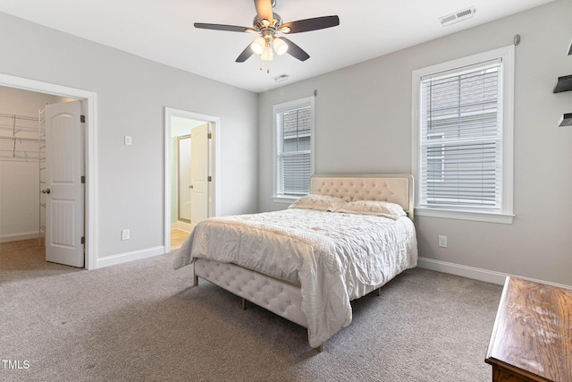 carpeted bedroom with visible vents, ceiling fan, and baseboards