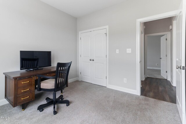 office space with baseboards and carpet flooring