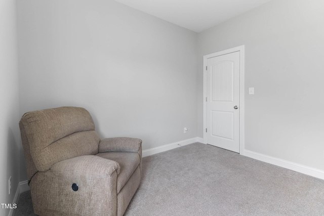 sitting room featuring carpet flooring and baseboards