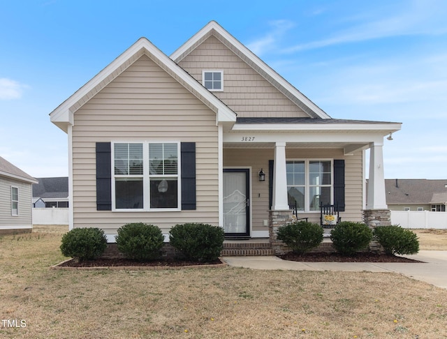 view of front of home featuring a front lawn and a porch