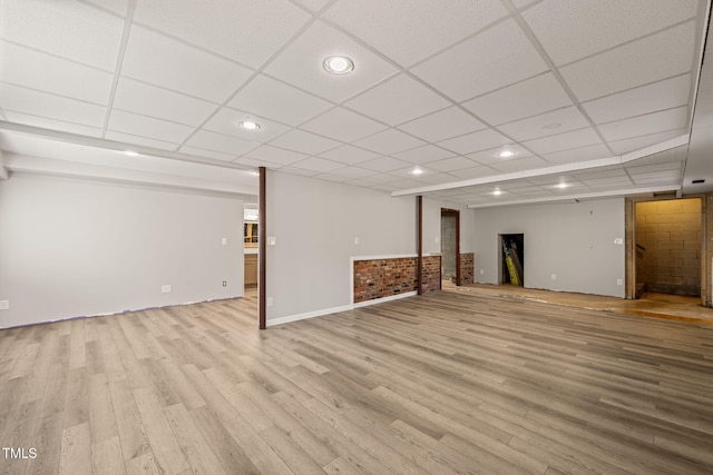 finished basement featuring a drop ceiling, wood finished floors, and recessed lighting