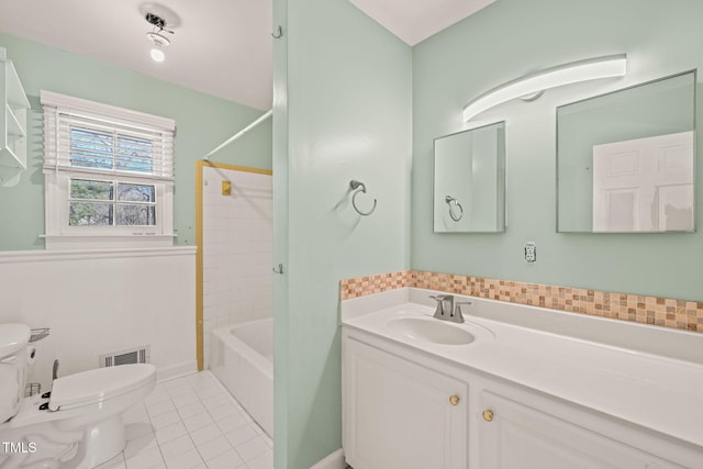 bathroom featuring visible vents, toilet, vanity,  shower combination, and tile patterned floors