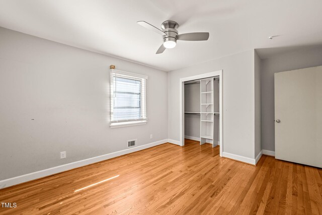 unfurnished bedroom with ceiling fan, light wood-style flooring, visible vents, baseboards, and a closet