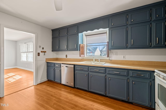 kitchen with light countertops, a ceiling fan, a sink, light wood-type flooring, and dishwasher