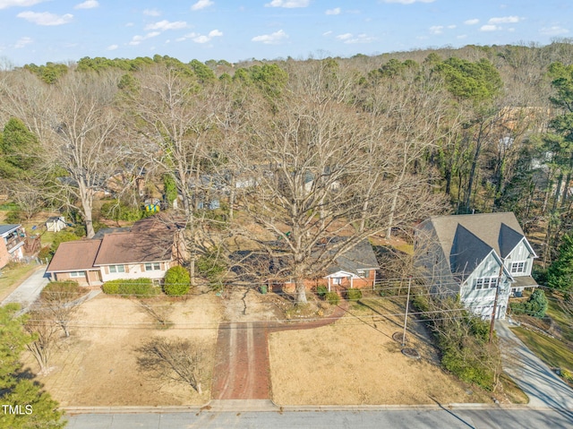 birds eye view of property featuring a view of trees