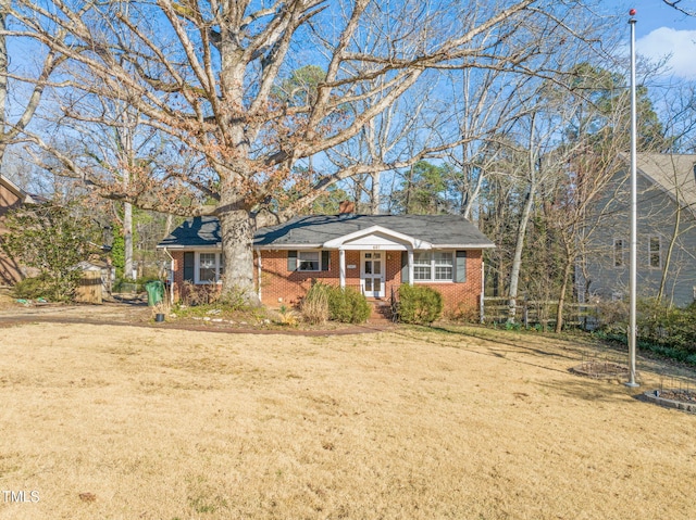 view of front of house with a front yard and brick siding