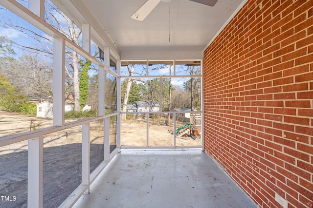 unfurnished sunroom featuring a ceiling fan