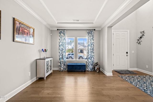3356 Longleaf Estates Dr, Raleigh, NC 27616 - entryway with visible vents, wood finished floors, baseboards, crown molding, and a raised ceiling