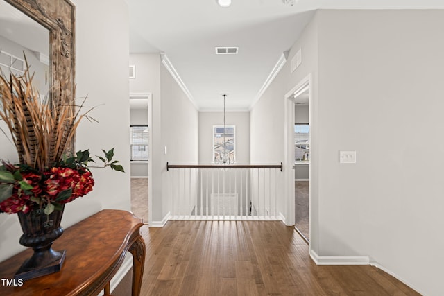 3356 Longleaf Estates Dr, Raleigh, NC 27616 - hall with crown molding, wood finished floors, visible vents, and baseboards