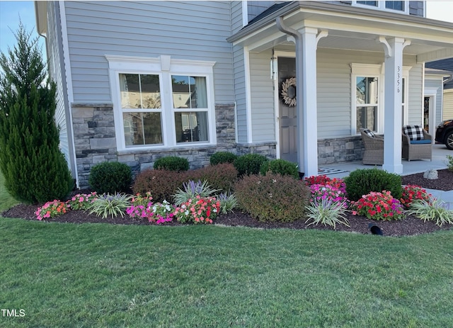 3356 Longleaf Estates Dr, Raleigh, NC 27616 - entrance to property featuring a yard, stone siding, and a porch