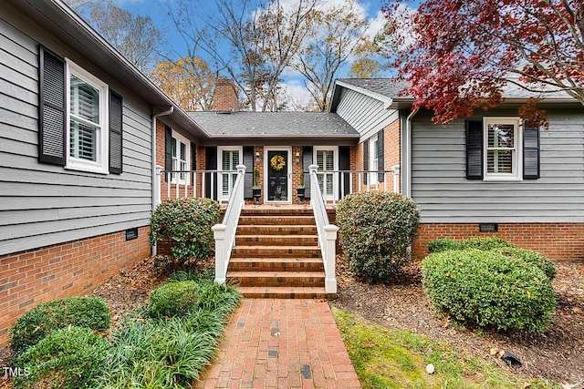 property entrance featuring crawl space and a chimney