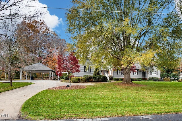 obstructed view of property featuring a carport, driveway, and a front lawn