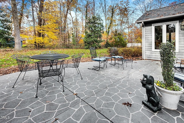 view of patio with outdoor dining space and fence