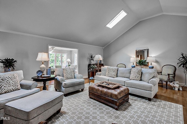 living room with lofted ceiling, baseboards, wood finished floors, and crown molding