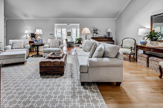 living room with a ceiling fan, crown molding, and wood finished floors