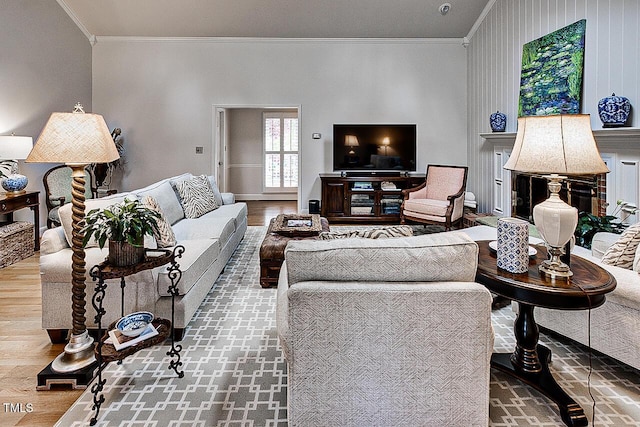 living area featuring wood finished floors and crown molding