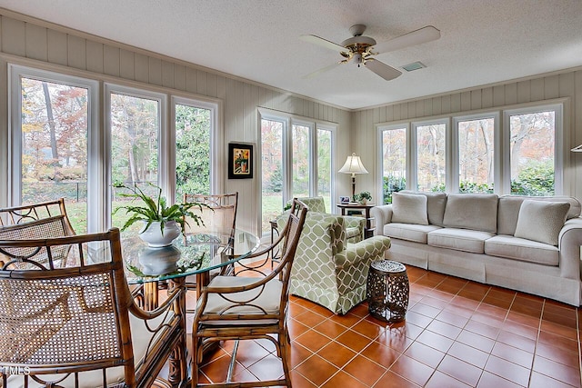 sunroom / solarium featuring visible vents and a ceiling fan