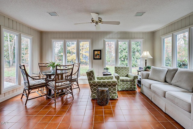 sunroom featuring visible vents and ceiling fan