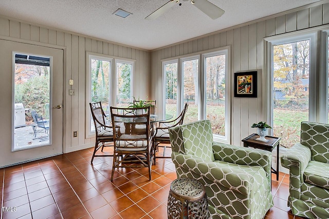 sunroom featuring plenty of natural light and ceiling fan