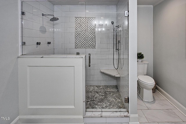 full bath featuring marble finish floor, baseboards, a shower stall, and toilet