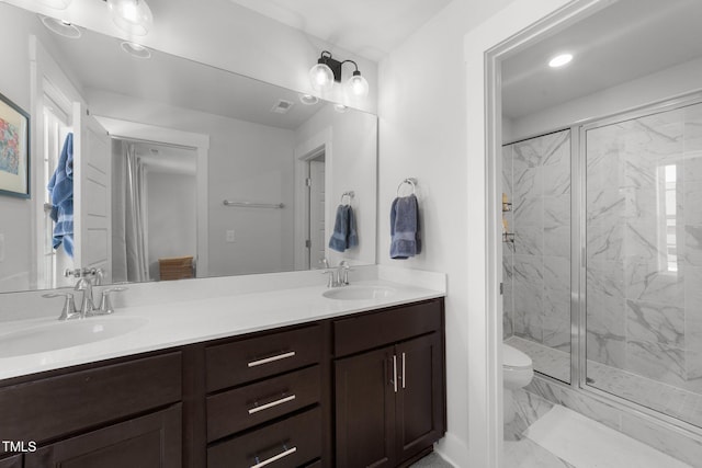 full bathroom with marble finish floor, a sink, a marble finish shower, and double vanity