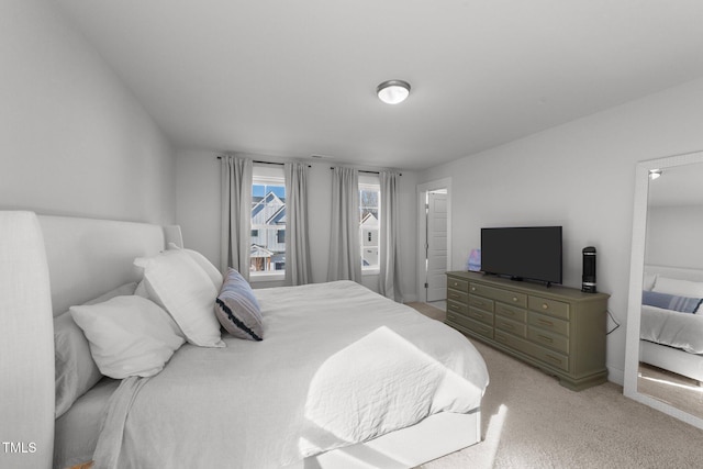 bedroom featuring light colored carpet