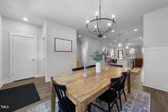 dining room featuring a notable chandelier, baseboards, dark wood-type flooring, and recessed lighting