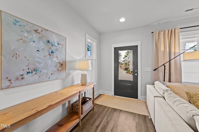 entryway with dark wood-style flooring, recessed lighting, visible vents, and baseboards