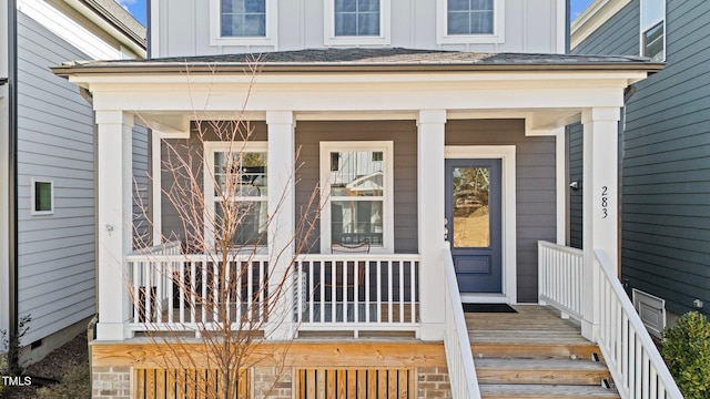 entrance to property featuring a porch and board and batten siding