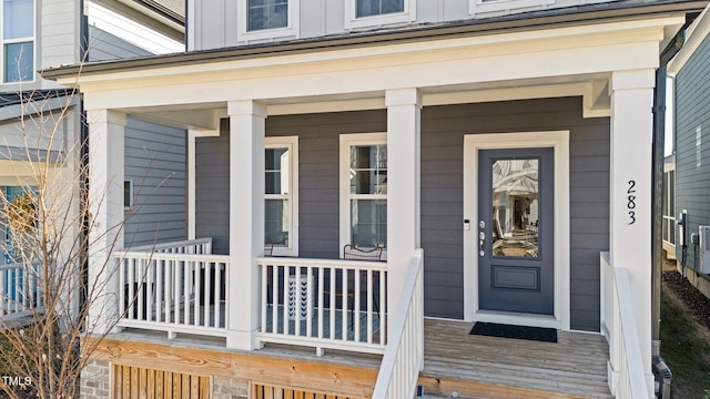 property entrance featuring a porch and board and batten siding