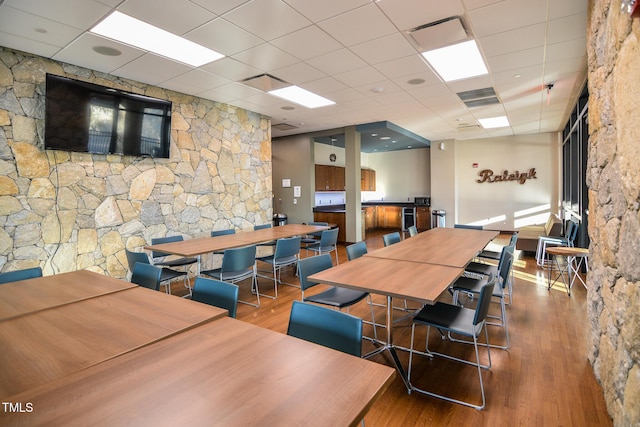 recreation room with visible vents, a drop ceiling, and wood finished floors