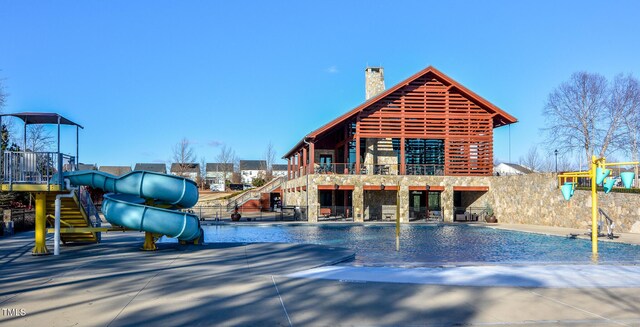 view of swimming pool with a playground