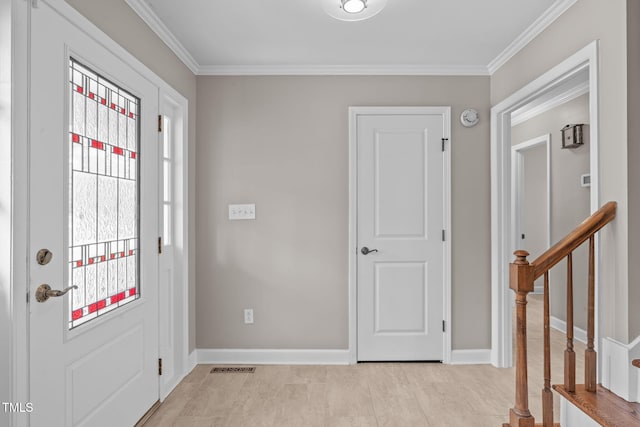 foyer featuring stairs, crown molding, baseboards, and visible vents