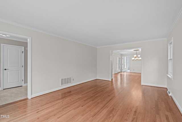 interior space featuring a notable chandelier, visible vents, light wood-style floors, and ornamental molding