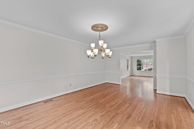 unfurnished room featuring visible vents, baseboards, light wood-style floors, crown molding, and a notable chandelier