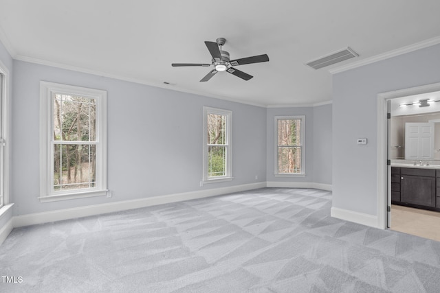 unfurnished bedroom featuring visible vents, light carpet, and ornamental molding