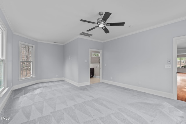 unfurnished room with ornamental molding, visible vents, and light carpet