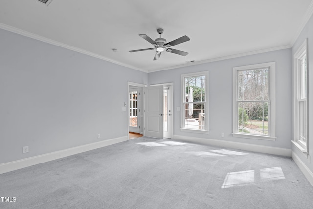 unfurnished room with ceiling fan, baseboards, carpet floors, and ornamental molding