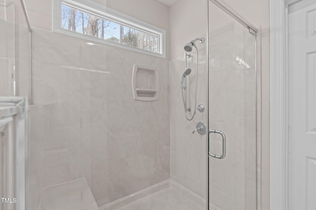 bathroom with a marble finish shower