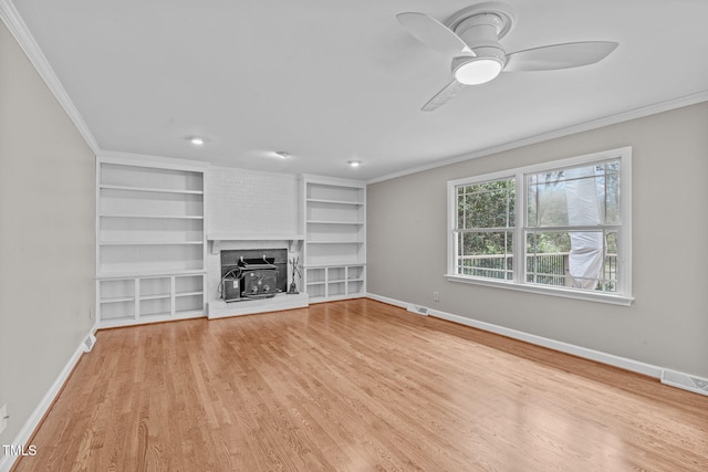 unfurnished living room with visible vents, light wood-style floors, baseboards, and ornamental molding