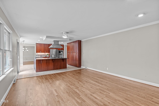 kitchen with light wood-style flooring, ornamental molding, extractor fan, appliances with stainless steel finishes, and ceiling fan with notable chandelier