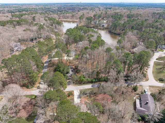 bird's eye view featuring a forest view and a water view