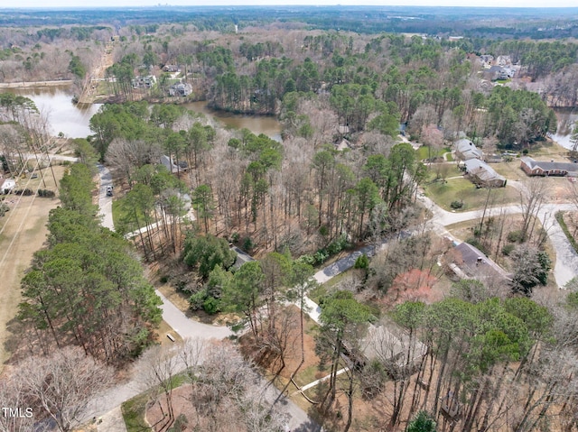 drone / aerial view with a water view and a view of trees