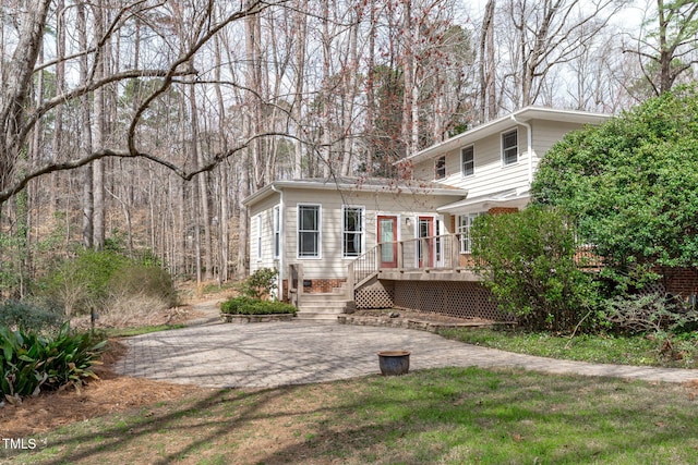 back of property featuring a patio, a deck, and driveway