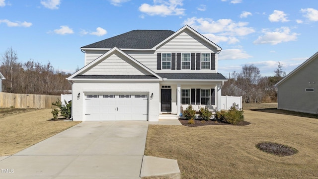 traditional home featuring a front yard, driveway, and fence