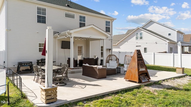 back of house with outdoor dining area, a patio area, fence private yard, and an outdoor living space