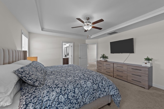 bedroom with carpet floors, a tray ceiling, crown molding, visible vents, and a ceiling fan