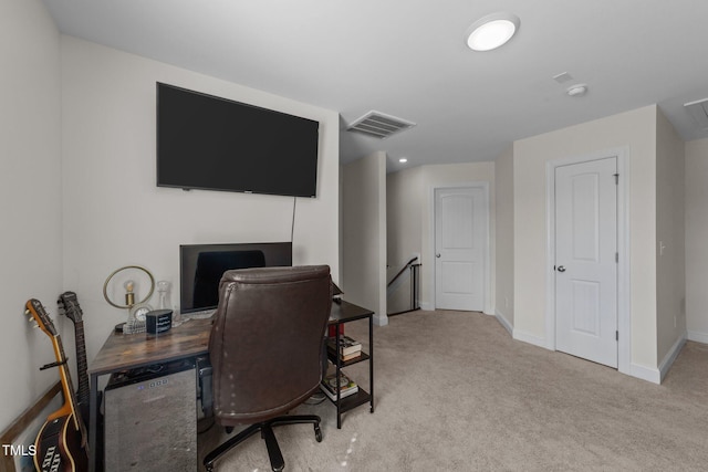 carpeted home office with visible vents and baseboards