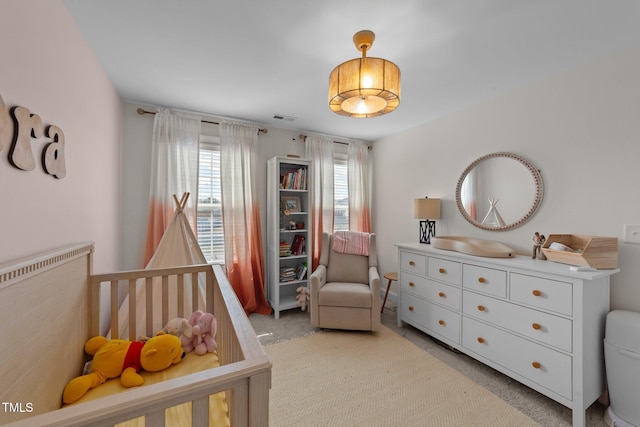 bedroom with visible vents and light colored carpet